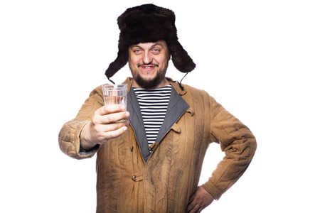 Happy russian man offering a vodka, cheers. Studio portrait isolated on white background  の写真素材