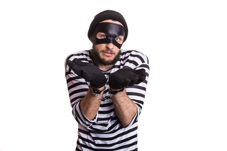 Sad criminal with handcuffs. Portrait isolated on white backgroundの写真素材