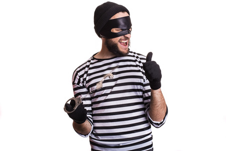 Thief escape from a jail. Portrait isolated on white backgroundの写真素材