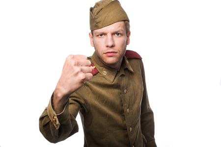 Angry russian soldier threaten with a fist. Studio portrait isolated on white backgroundの写真素材