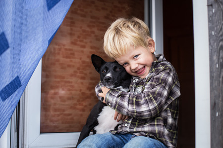 Love between child and his pet. Outdoor portraitの写真素材