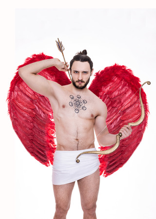 Sexy young man with big red wings. Cupid, Valentine, Archangel, Angel. Studio portrait isolated over white backgroundの写真素材