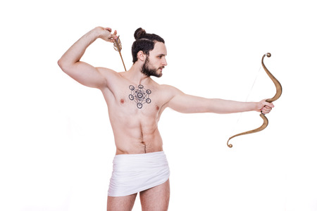 Tough man with bow and arrows. Cupid, Valentine, Greece, Antiquity. Studio portrait isolated over white backgroundの写真素材