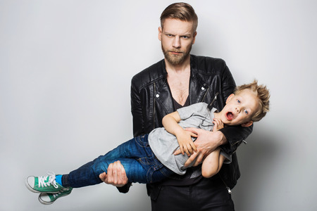 The portrait of a little boy and his father. Fathers day. Studio portrait over white backgroundの写真素材