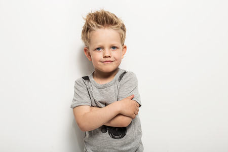 Portrait of happy joyful beautiful little boy. Studio portrait over white backgroundの写真素材