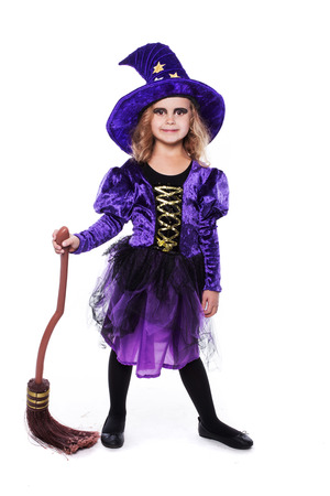 Adorable little blond girl wearing a witch costume smiling at the camera. Halloween. Fairy. Tale. Studio portrait isolated over white backgroundの写真素材
