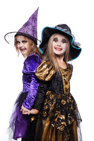 Witch children with trick or treat. Halloween. Fairy. Tale. Studio portrait isolated over white backgroundの写真素材