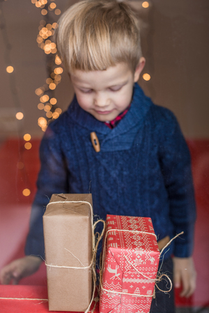 Happy Young Blond Boy with Gift Box. Christmas. Birthdayの写真素材