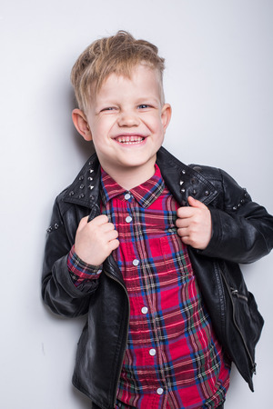 Fashionable child in leather jacket. Studio portrait over white backgroundの写真素材