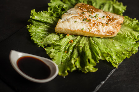 Grilled pangasius with sauce. Seafood. Fish dish. Restaurantの写真素材