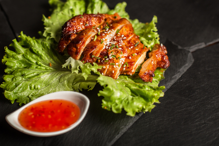 Grilled chicken breast with sesame seeds. Sweet and sour sauce. Restaurantの写真素材