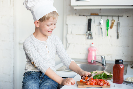 Kid chef is cooking in the kitchen at home. Healthy foodの写真素材