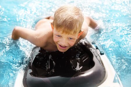 Little boy with surfboard having fun. Vacation, summer and childhood conceptの写真素材