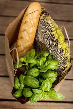 Various healthy food in paper bag on wooden background. Healthy food from the storeの写真素材