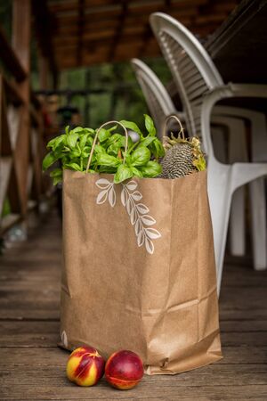 Various healthy food in paper bag on wooden background. Healthy food from the storeの写真素材