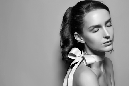 Black and white tender fashion portrait of Beautiful gentle young brunette woman の写真素材