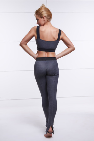 Beautiful sexy blonde with perfect athletic slim figure engaged in yoga, pilates, exercise or fitness, lead healthy lifestyle, and eats right relaxes meditationの写真素材