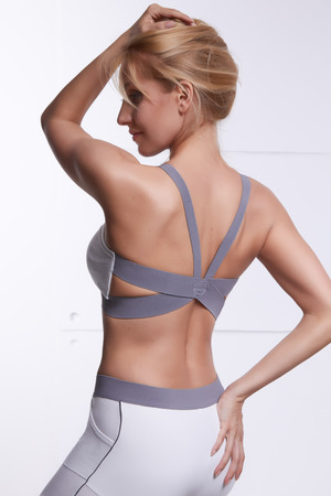 Beautiful sexy blonde with perfect athletic slim figure engaged in yoga, pilates, exercise or fitness, lead healthy lifestyle, and eats right relaxes meditationの写真素材