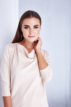 Portrait of beautiful sexy woman skin beauty fashion model glamor jewelry cosmetic makeup cream natural style clothes foundation rouge mascara care plastic surgery accessories earrings ring bracelet.の写真素材