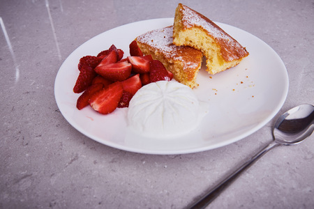 White ceramic porcelain piece of carrot pie plate sweet dessert sprinkled powder sugar fresh strawberry ice cream delicious healthy nutritious breakfast diet product natural food ingredient spoon.の写真素材