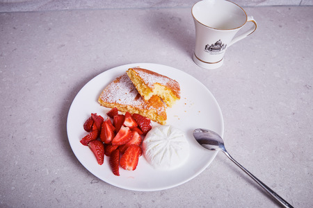 White ceramic porcelain piece apple pie plate spoon cup sweet dessert sprinkled with powder sugar fresh strawberry ice cream delicious healthy breakfast diet product natural organic food ingredient.の写真素材
