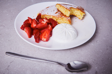 White ceramic porcelain piece of carrot pie plate sweet dessert sprinkled powder sugar fresh strawberry ice cream delicious healthy nutritious breakfast diet product natural food ingredient spoon.の写真素材