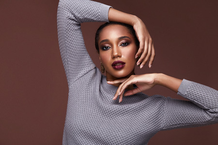 Sexy beauty woman pretty face tan skin wear blue knitted suit skirt long body shape makeup cosmetic collection studio catalog brunette accessory clothes for office dress code party fashion shoes.の写真素材