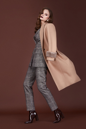 Beautiful sexy woman wear for meeting date business style suit jacket pants cashmere coat accessory fashion collection shoes model pose long brunette hair natural make up businesswoman casual clothes.の写真素材