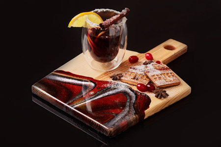Exclusive painted art cutting board made of wood organic serving dishes with taste food cuisine hot drink wine cinnamon and citrus lemon sweet cookie biscuit berry dogwood sugar.の写真素材