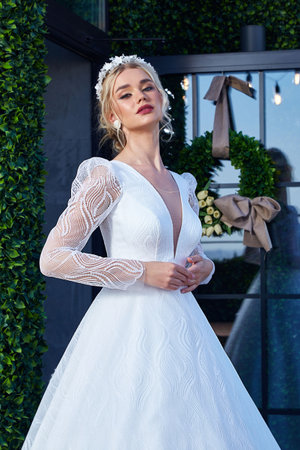 Beautiful tender young woman sexy brunette bride in a luxury white wedding dress lace chiffon Summer happiness awaits the groom before the wedding ceremony makeup accessory jewelry smile.の写真素材