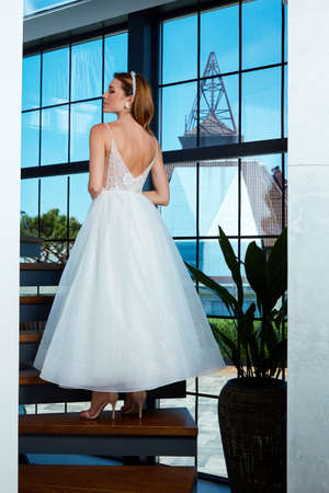 Sexy beautiful brunette woman pretty bride wedding big day marriage ceremony in summer garden wearing long silk and lace white dress bright makeup hairstyle pure love interior.の写真素材