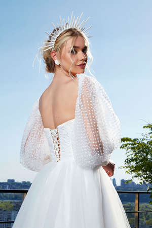 Sexy beautiful blonde woman pretty bride wedding big day marriage ceremony in summer garden wearing long silk and lace white dress bright makeup hairstyle pure love interior.の写真素材