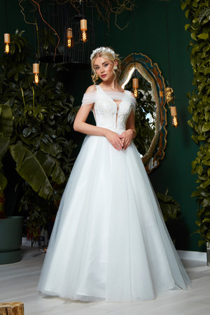 Beautiful woman bride fashion model blond hair bright makeup pretty wear long silk white dress with lace bridal ceremony wedding espousal in blooming romance garden party marriage happy big day.の写真素材