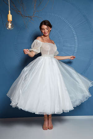 Sexy beautiful brunette woman pretty bride wedding big day marriage ceremony in summer garden wearing long silk and lace white dress bright makeup hairstyle pure love interior.の写真素材