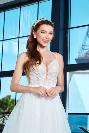 Sexy beautiful brunette woman pretty bride wedding big day marriage ceremony in summer garden wearing long silk and lace white dress bright makeup hairstyle pure love interior.の写真素材