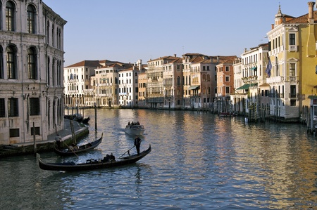 Gondolas cruzing the Venice canals in the afternoonの写真素材