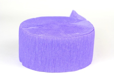 Purple party streamer roll on white backgroundの写真素材