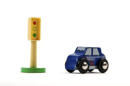 Toy stop light and police car on white backgroundの写真素材