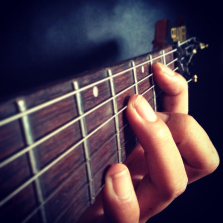 Close up finger on the guitar