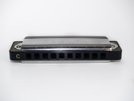 A closeup of a harmonica isolated in a white background.の写真素材
