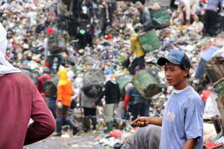 a man working as trash monger in Bantar Gebang dumpster, Jakarta, Indonesiaのeditorial素材