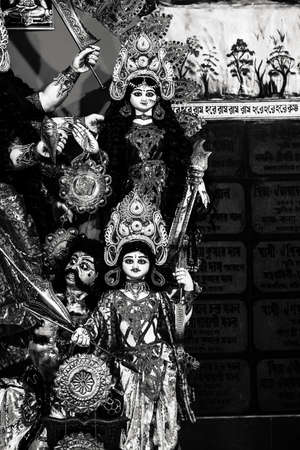 Decorated sculpture of goddess Durga idol on lion with ten arms at pandal and temple in colored light. Durga Puja is big cultural Hindu religious festival in west Bengal, India. Navaratri background.の写真素材