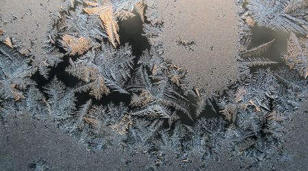 Frost patterns on the window. Winter morning.の写真素材