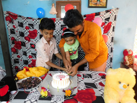 Closeup view of peoples(Kid, Boy and Man)with food(Cake) and other equipment's in a birthday...