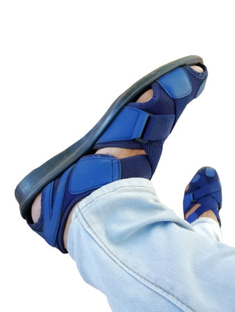 Human foot with blue shoe white background closeup viewの写真素材