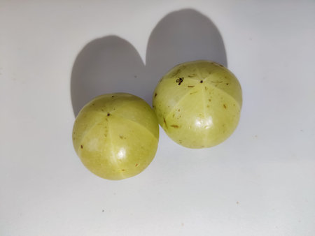 selective focus on delicious gooseberry and its shadows isolated on white background closeup shot