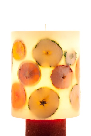 Big fruit candle back-lighted on white backgroundの写真素材