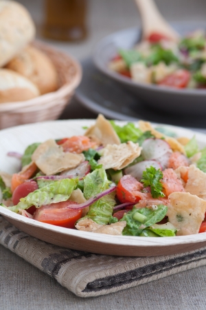 Very tasty Arabic salad  Fattoush  served in bamboo leaf plate, main focus on first onion sliceの写真素材