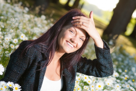 Beutiful smiling happy woman on field of flowersの写真素材