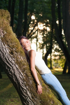 Beutiful woman in green parkの写真素材
